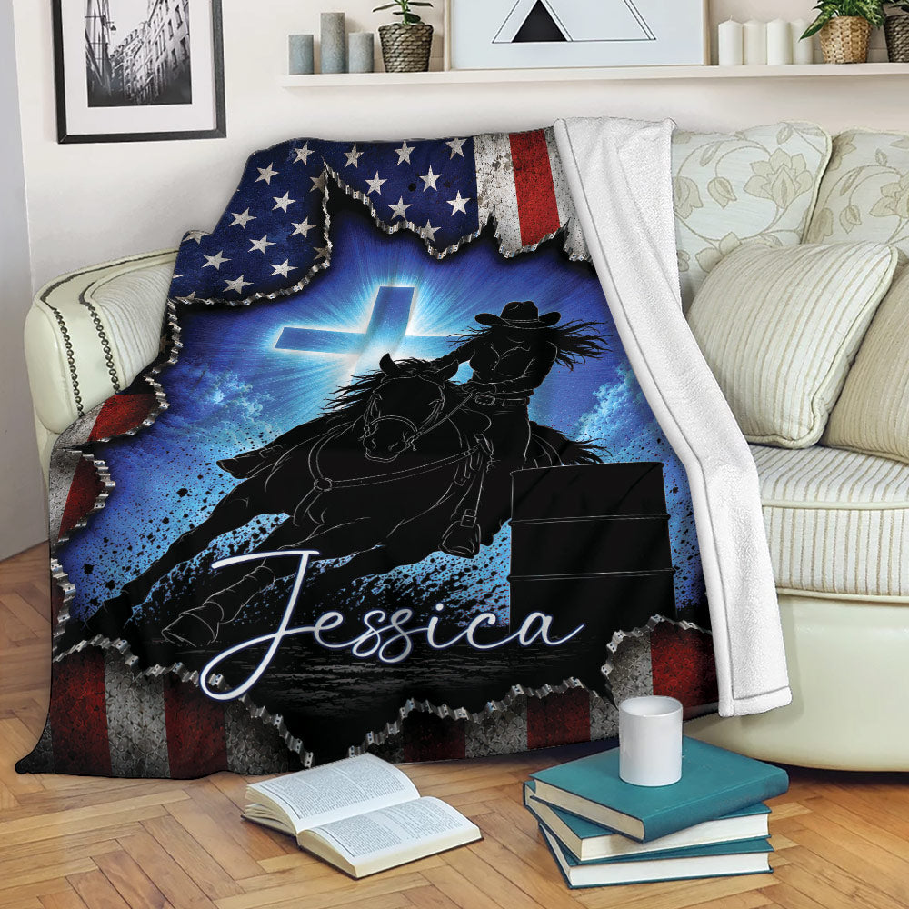 Barrel racing throw blanket displayed on a sofa with western horse and rider artwork