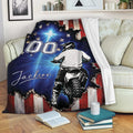 Motocross blanket displayed on a couch with dirt bike rider artwork and distressed patriotic flag design
