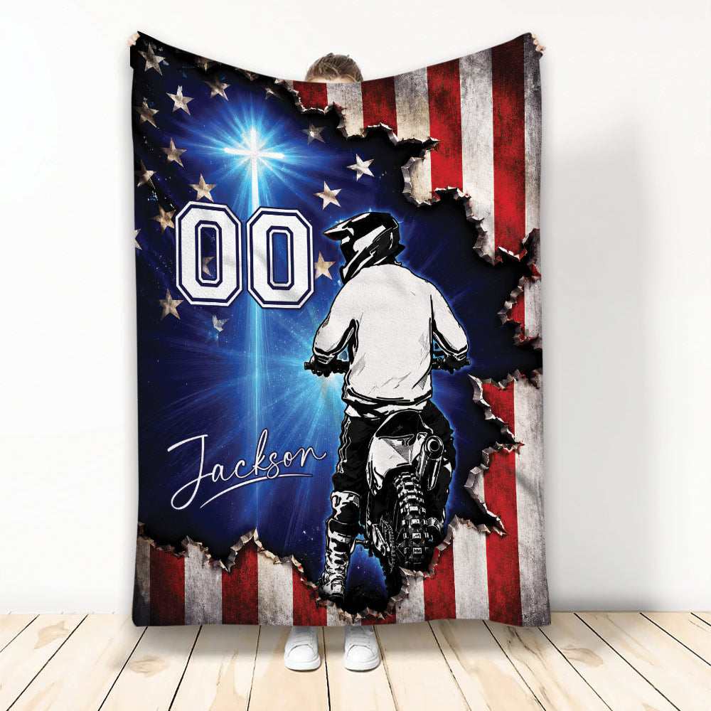 Motocross throw blanket with dirt bike rider artwork, patriotic flag design, and blue starburst background