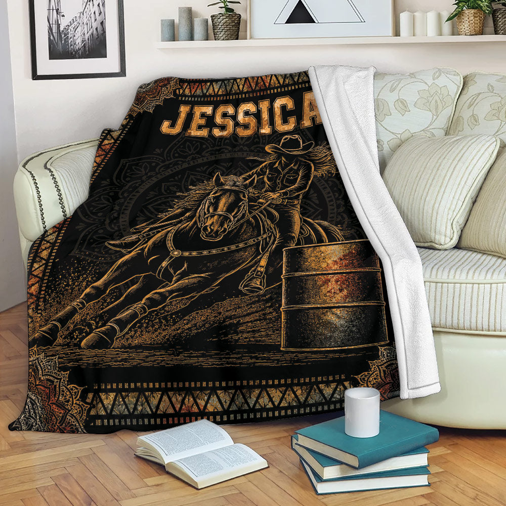 Barrel racing throw blanket draped over a sofa with horse, rider, and barrel artwork