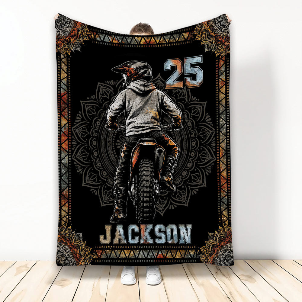 Motocross throw blanket displayed upright with dirt bike rider artwork and bold black, orange, and gray styling