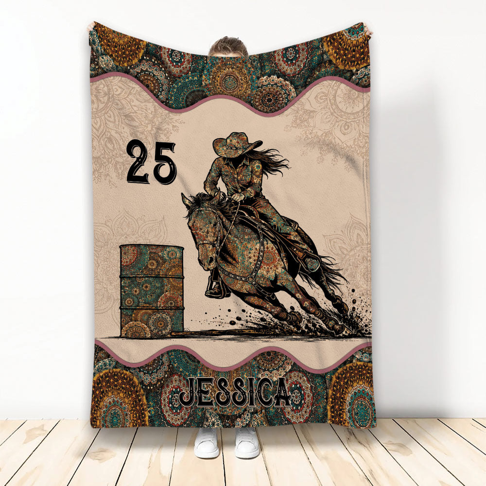 Barrel racing throw blanket featuring a mounted rider, horse, barrel, and ornate Western paisley artwork