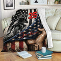 Motocross blanket draped over a sofa with dirt bike rider artwork and patriotic star details