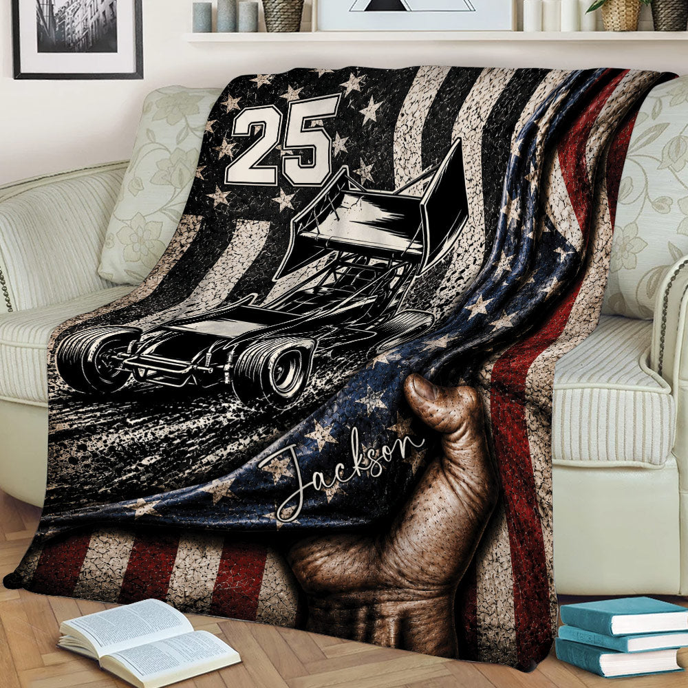 Sprint car dirt track racing blanket draped over a sofa, featuring bold racing artwork, stars, and vintage stripes