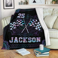 Custom racing blanket draped over a sofa with checkered flag artwork and neon accents