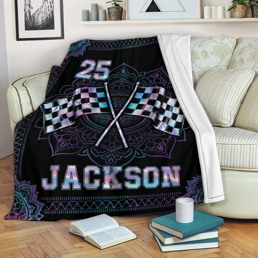 Custom racing blanket draped over a sofa with checkered flag artwork and neon accents