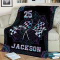 Racing throw blanket displayed on a couch with crossed flags and decorative blue and purple details