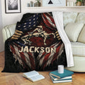 Patriotic wrestling throw blanket displayed across a sofa with dramatic grappling artwork and distressed flag details