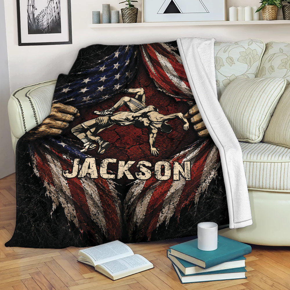 Patriotic wrestling throw blanket displayed across a sofa with dramatic grappling artwork and distressed flag details
