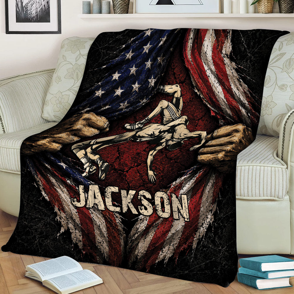 Wrestling blanket draped over a couch, featuring two grapplers, bold flag-inspired artwork, and a rugged distressed style