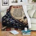 Wrestling throw blanket displayed on a sofa with patriotic artwork and motivational sports-themed text