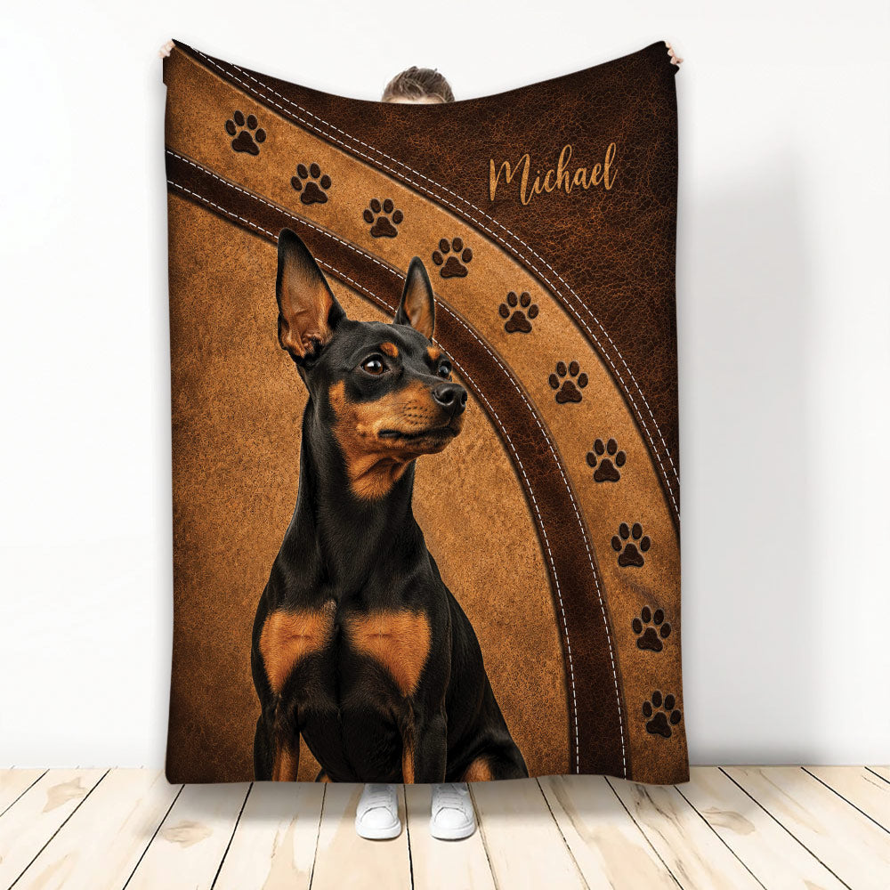 Miniature Pinscher blanket with black and tan dog artwork, paw prints, and brown leather-look accents