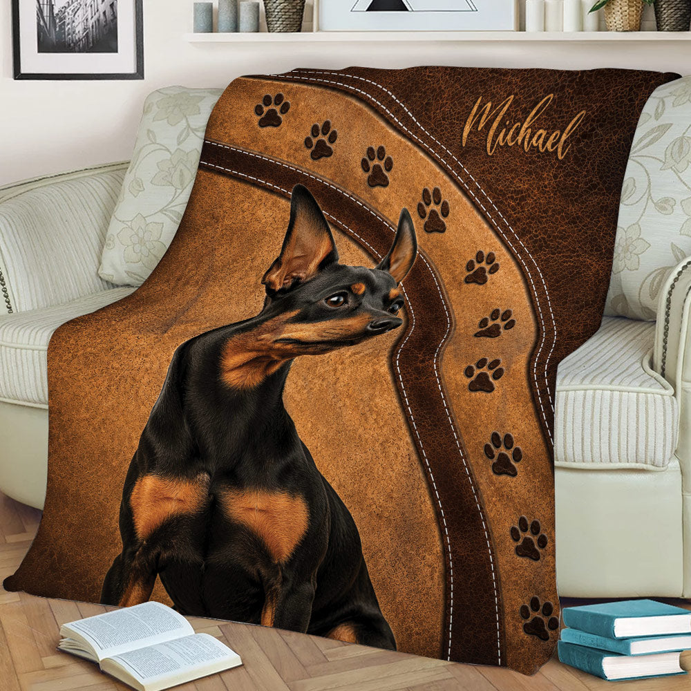 Miniature Pinscher blanket styled on a couch with black and tan dog artwork and paw print bands