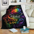 LGBT pride throw blanket displayed on a sofa with a vibrant rainbow rose and colorful love-themed artwork