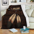American Native blanket draped over a sofa with feather and arrow artwork in rich earthy tones