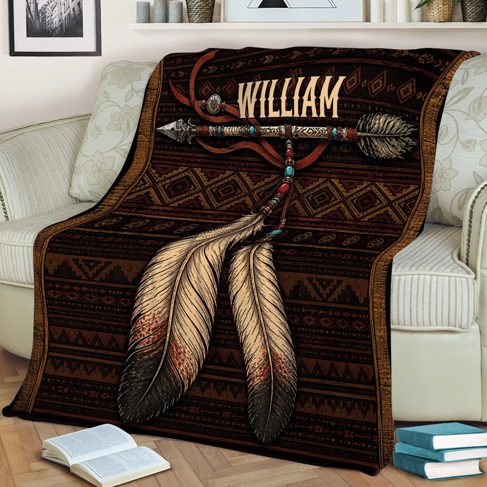 Close view of an American Native throw blanket featuring geometric bands and large feather artwork