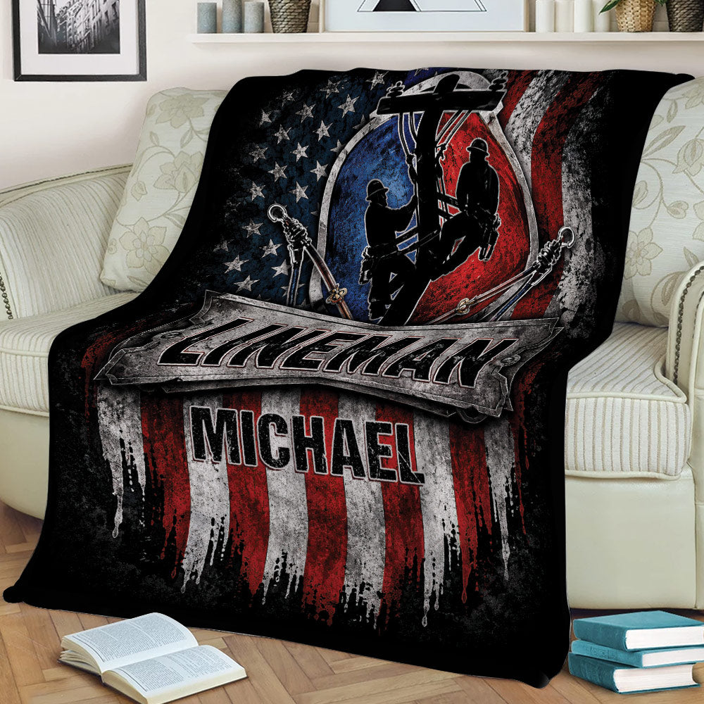 Lineman throw blanket draped over a sofa with pole climbing silhouettes and distressed flag design