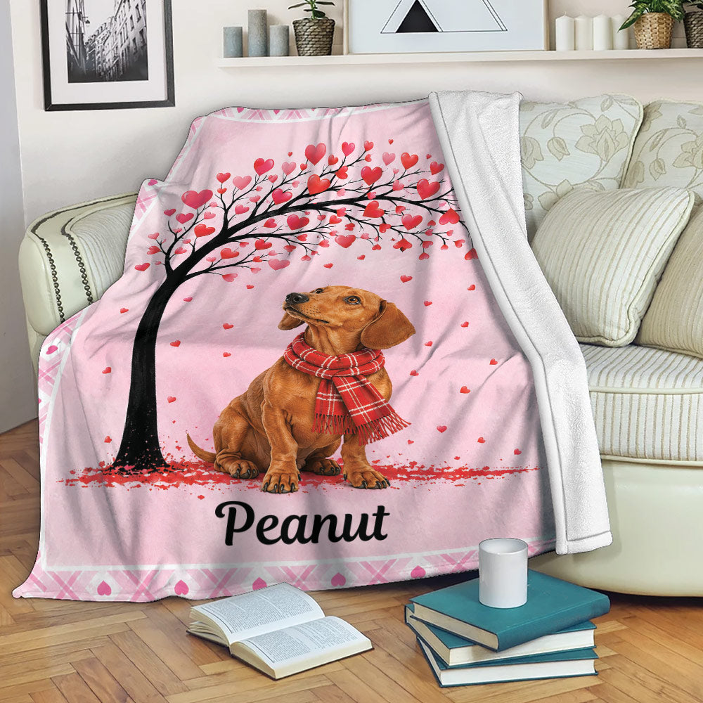 Dachshund throw blanket displayed on a sofa with a heart tree design and pink border