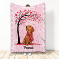 Dachshund blanket with a red scarf beneath a heart-covered tree on a pink background