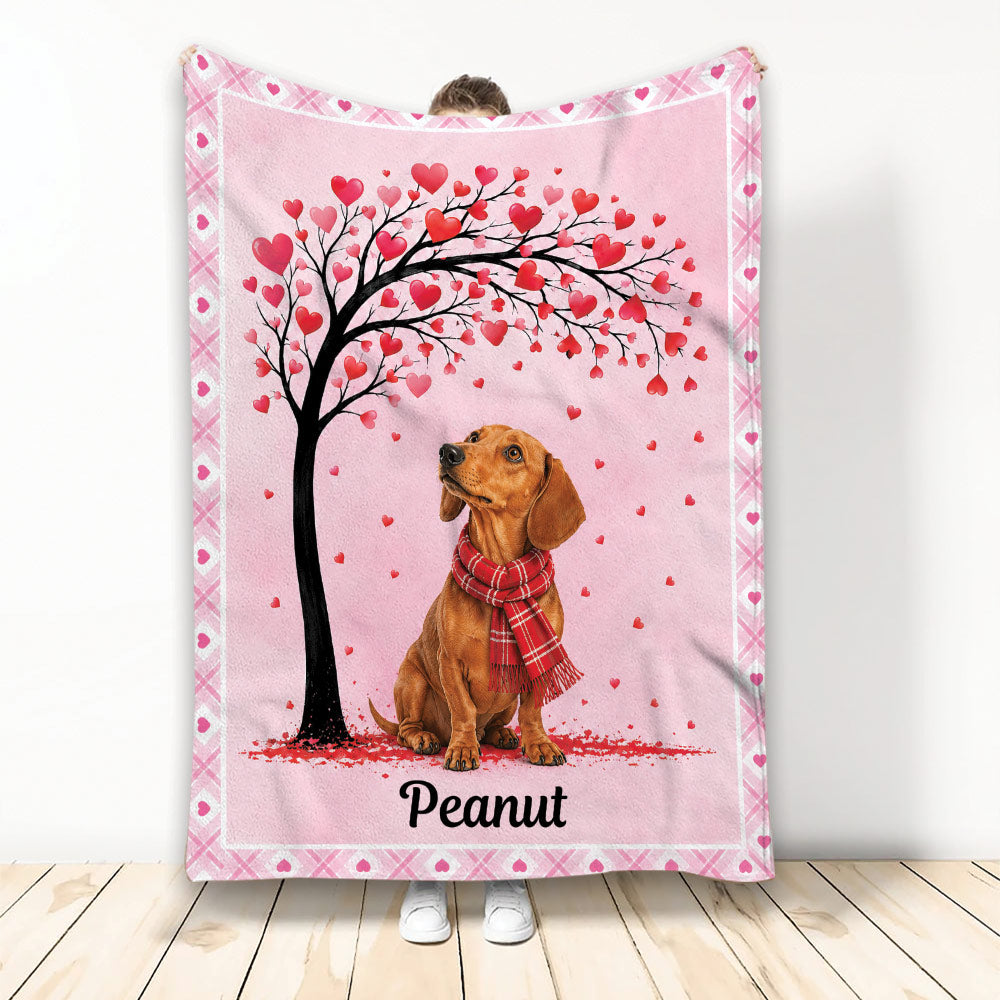 Dachshund blanket with a red scarf beneath a heart-covered tree on a pink background