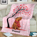 Pink dachshund throw blanket draped over a sofa with heart-covered tree artwork