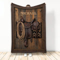Cowboy throw blanket featuring a Western saddle, coiled rope, wood texture and rustic leather-style border