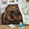 Rustic cowboy blanket draped over a sofa with Western boots and a cowboy hat artwork