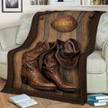 Western cowboy blanket displayed across a sofa with detailed hat and boot artwork