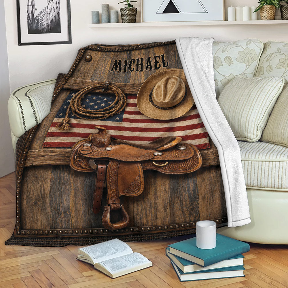 Western cowboy throw blanket displayed on a sofa with saddle, hat, lasso, and flag design