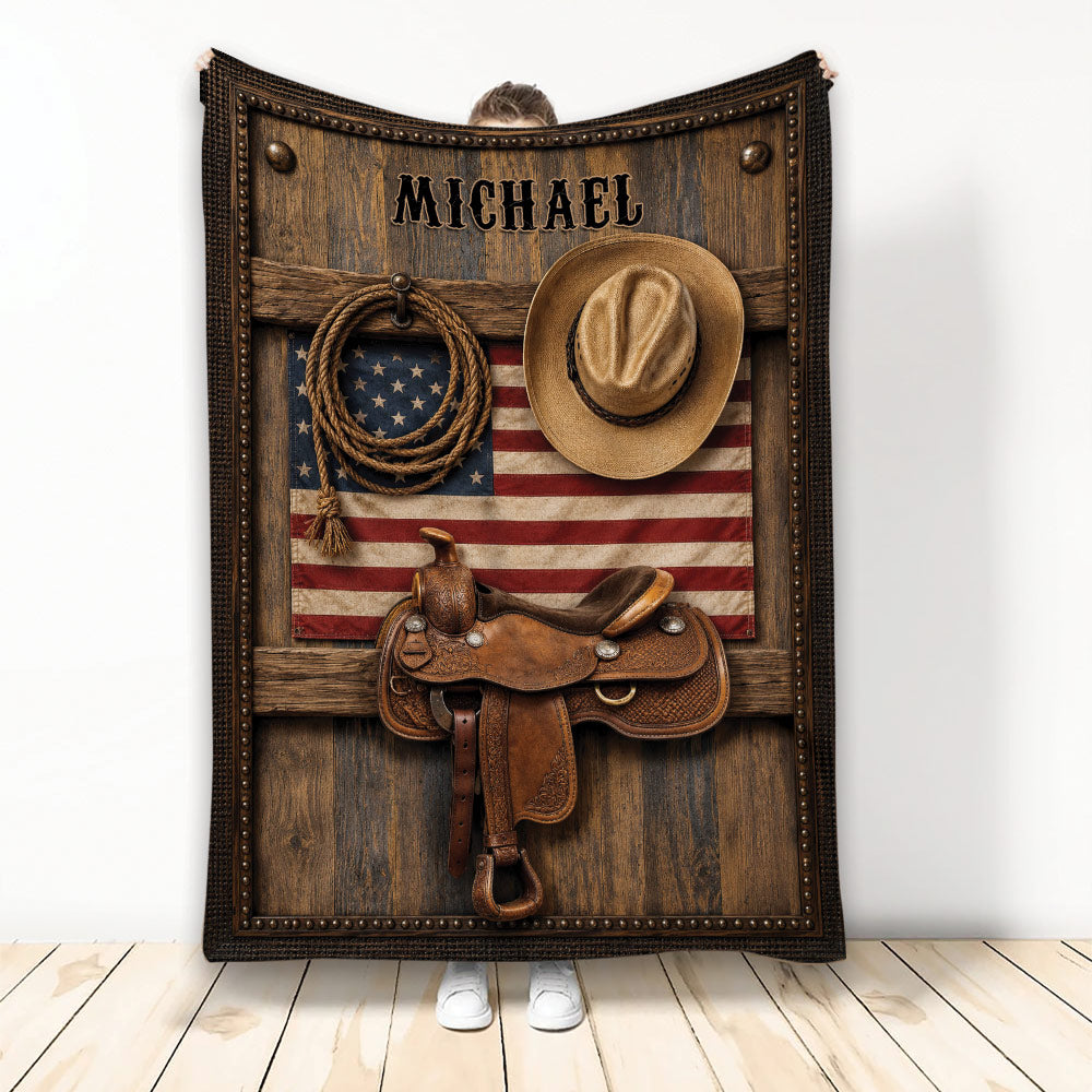 Cowboy blanket featuring a western saddle, hat, lasso, rustic wood, and patriotic flag artwork