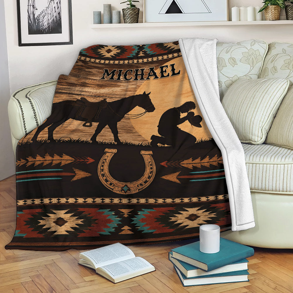 Cowboy blanket displayed on a sofa with horse silhouette, horseshoe artwork, and rustic Southwestern patterns