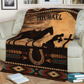 Rustic cowboy throw blanket draped over a couch with horse, horseshoe, western rider, and geometric artwork