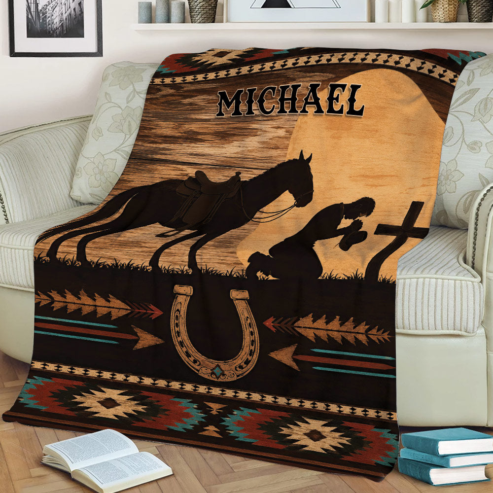 Rustic cowboy throw blanket draped over a couch with horse, horseshoe, western rider, and geometric artwork