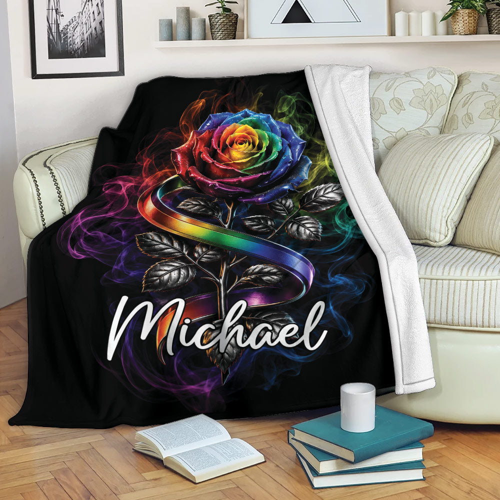 Rainbow pride rose blanket draped over a sofa in a cozy living room setting