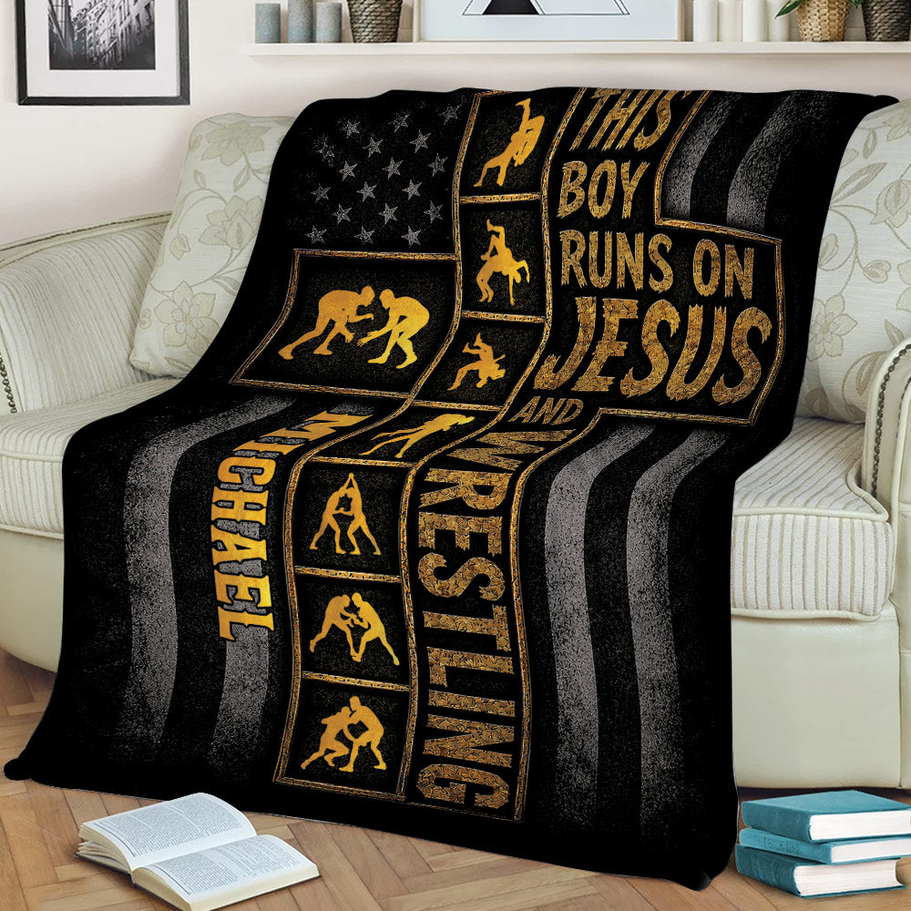 Black and gold wrestling blanket draped over a couch with multiple wrestling silhouettes