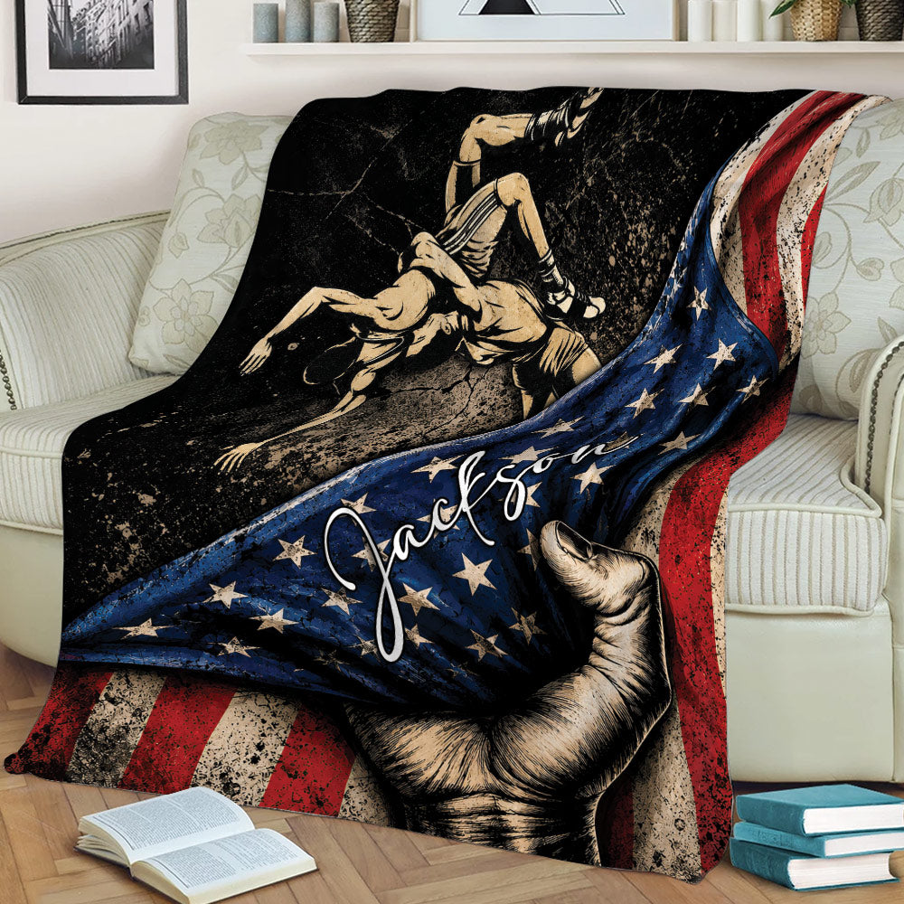 Custom wrestling blanket draped over a couch with grappling artwork and distressed flag-inspired design