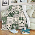 Chicken throw blanket draped over a sofa, featuring rustic rooster artwork, green plaid, and farmhouse patchwork styling