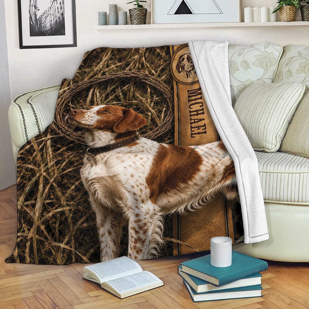 Brittany Spaniel blanket draped over a sofa with rustic field artwork in a cozy living room