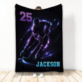 Black hockey throw blanket with an illuminated ice hockey player skating with a stick and puck