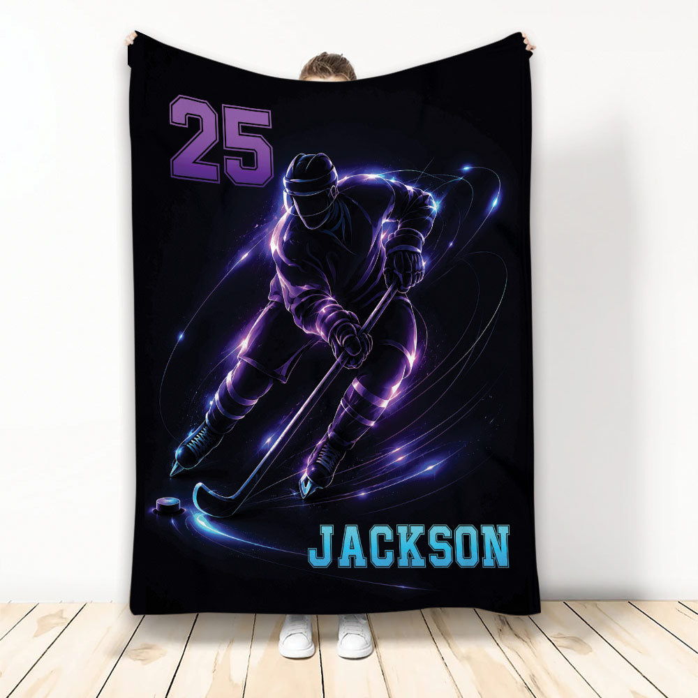 Black hockey throw blanket with an illuminated ice hockey player skating with a stick and puck