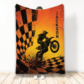 Motocross throw blanket featuring a dirt bike rider, orange and black checkered flags, and action-inspired artwork