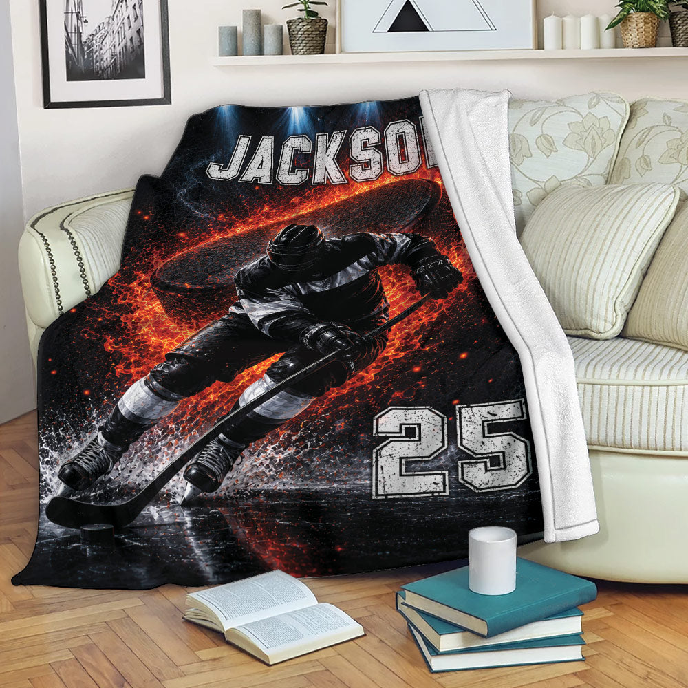 Hockey throw blanket draped over a sofa, showing dynamic ice hockey artwork in black, white, and vivid red