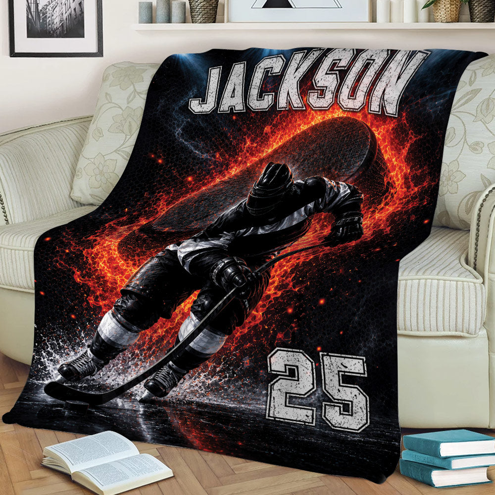 Ice hockey throw blanket displayed on a couch with a skating player, puck, stick, and dramatic fiery sports design