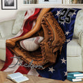 Patriotic baseball throw blanket displayed on a sofa with a glove, bat, baseball, and star details