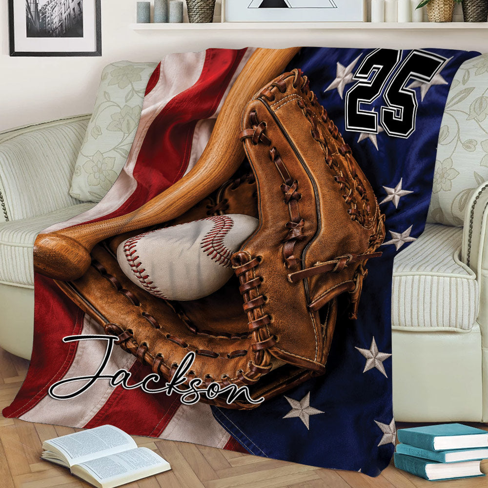 Patriotic baseball throw blanket displayed on a sofa with a glove, bat, baseball, and star details