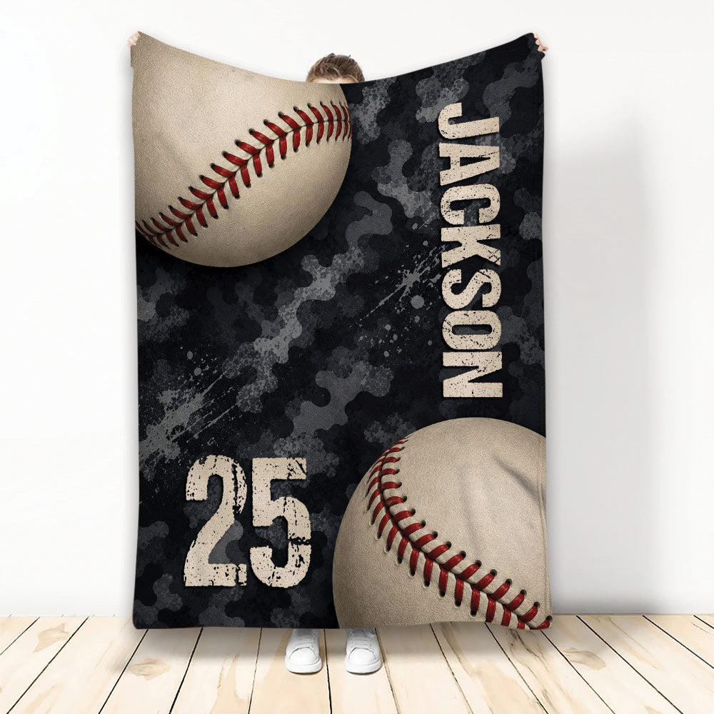 Baseball throw blanket with large baseballs, dark camouflage artwork, and distressed sports styling