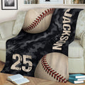 Baseball throw blanket styled on a couch with bold baseball imagery and rugged camouflage design