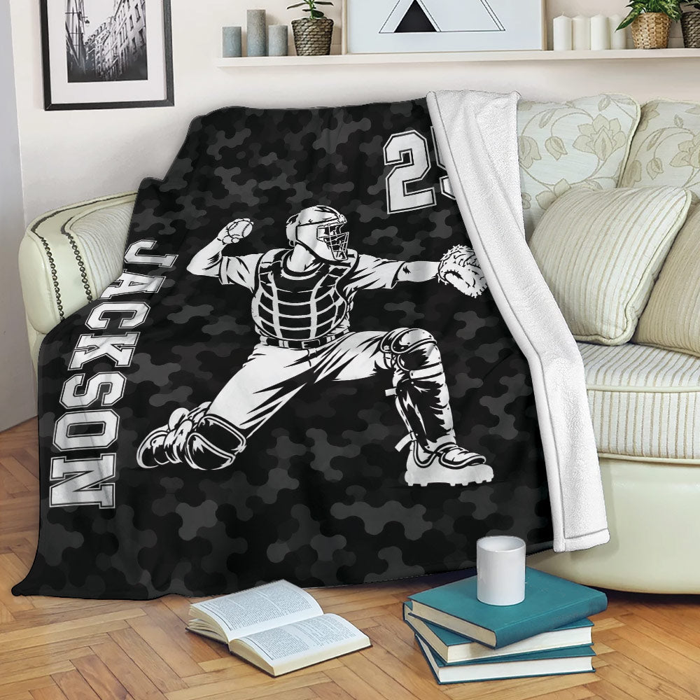 Baseball catcher blanket draped over a sofa with black camouflage sports design