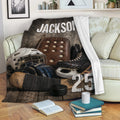 Hockey blanket draped over a sofa with rustic equipment artwork and sports-themed room decor