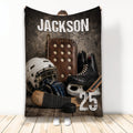 Hockey throw blanket displayed upright with vintage gear artwork, helmet, skates, stick and puck